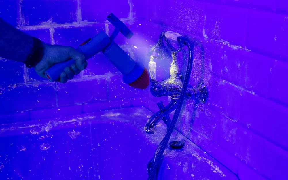 Illustration of a spin scrubber beside a tiled bathroom wall